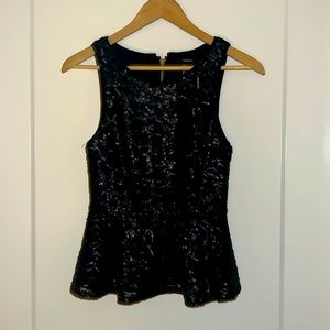 black sequins sleeveless shirt.